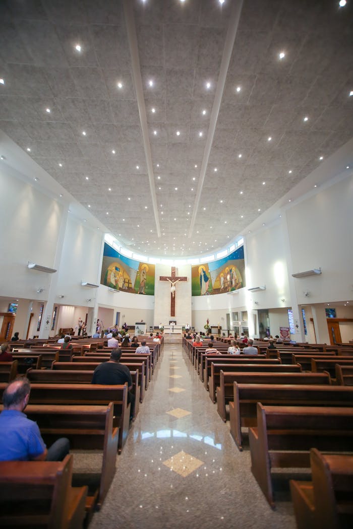 Panoramic view of parishioners in a modern church interior during a service.