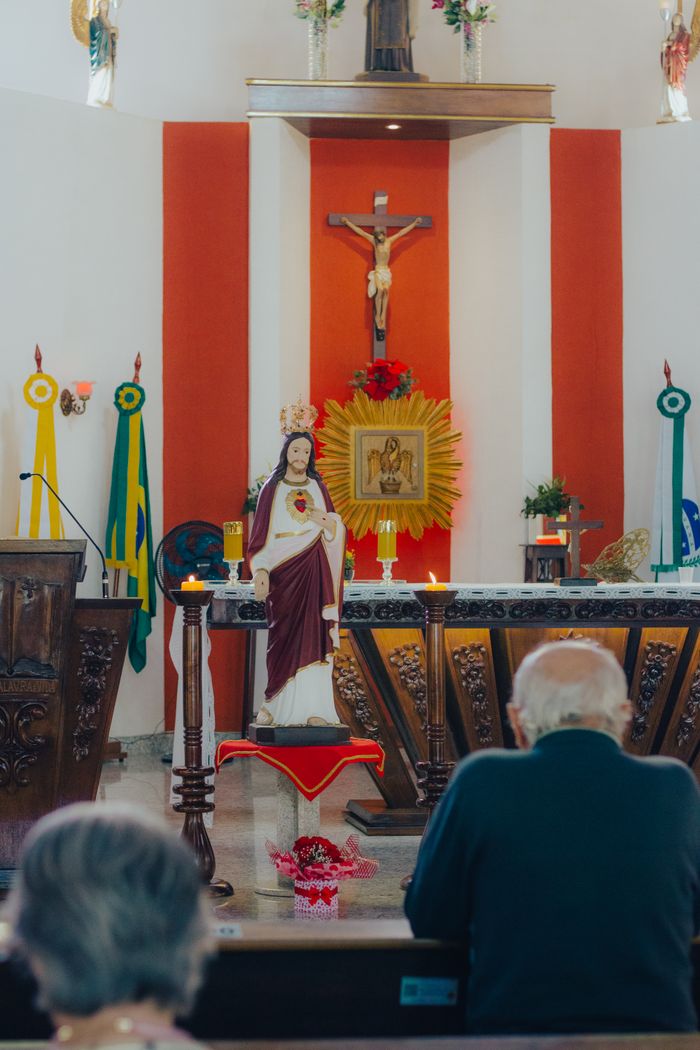 Interior of a Catholic church featuring altar and religious statues.